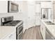 Bright kitchen features stainless steel appliances, white cabinets, and quartz countertops at 17417 E 89Th Way, Commerce City, CO 80022