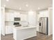 Bright kitchen features white cabinets, stainless steel appliances, and a stylish tile backsplash at 17417 E 89Th Way, Commerce City, CO 80022