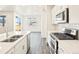 Open kitchen layout with stainless steel appliances, an island, and lots of natural light at 17417 E 89Th Way, Commerce City, CO 80022
