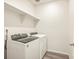 Laundry room equipped with modern washer and dryer, and a shelf for storage solutions at 17417 E 89Th Way, Commerce City, CO 80022