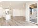 Open-concept living room and kitchen area with vinyl floors and lots of bright, natural light at 17417 E 89Th Way, Commerce City, CO 80022