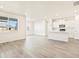 Open concept living room and kitchen features vinyl flooring and white trim and walls at 17417 E 89Th Way, Commerce City, CO 80022