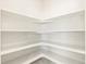 A white pantry has multiple shelves that wrap around the interior of the space at 17417 E 89Th Way, Commerce City, CO 80022