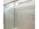 Elegant shower with tiled walls, a glass door, and a modern shower head at 17417 E 89Th Way, Commerce City, CO 80022