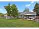 A large backyard with a shed, hot tub, wooden deck, and outdoor furniture at 5870 S Perth Pl, Centennial, CO 80015