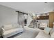 Basement living area with barn door to the laundry and carpeted stairs at 5870 S Perth Pl, Centennial, CO 80015