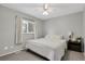 Bright bedroom with a white bed, white curtains, and a ceiling fan providing a serene and inviting atmosphere at 5870 S Perth Pl, Centennial, CO 80015