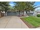 Lovely home featuring a two-car garage, mature trees, and a well-maintained lawn at 5870 S Perth Pl, Centennial, CO 80015