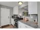 Well-equipped kitchen featuring granite countertops, stainless steel appliances, and ample cabinet space at 5870 S Perth Pl, Centennial, CO 80015