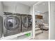 Modern laundry room featuring updated washer and dryer and access to the basement at 5870 S Perth Pl, Centennial, CO 80015