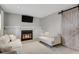 Cozy living room with a fireplace, sliding barn door, and neutral décor at 5870 S Perth Pl, Centennial, CO 80015