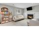 Relaxing living room with a fireplace, large screen TV and plenty of seating at 5870 S Perth Pl, Centennial, CO 80015
