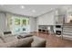 Bright living room with hardwood floors, a fireplace, and access to the backyard at 5870 S Perth Pl, Centennial, CO 80015