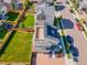 Home aerial showcasing a well-manicured yard, solar panels, brick driveway, and neighborhood setting at 10071 Yampa Ct, Commerce City, CO 80022