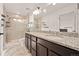 Modern bathroom featuring double sinks, granite countertops, and a tiled walk-in shower at 10071 Yampa Ct, Commerce City, CO 80022