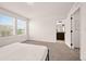 Bright bedroom with large windows, neutral carpet, and ensuite bathroom entrance for easy accessibility at 10071 Yampa Ct, Commerce City, CO 80022