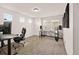 Spacious room with carpeted floors, two large windows, and modern fixtures at 10071 Yampa Ct, Commerce City, CO 80022