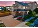 Beautiful two-story home featuring solar panels, a brick driveway, and colorful landscaping at 10071 Yampa Ct, Commerce City, CO 80022