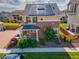 Aerial view of a two-story home with solar panels, landscaping, and a welcoming front porch at 10071 Yampa Ct, Commerce City, CO 80022