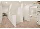 Well-lit hallway showcasing carpeted floors and a glimpse of the connecting rooms at 10071 Yampa Ct, Commerce City, CO 80022