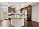 An open kitchen features dark cabinetry, stainless appliances, and granite countertops at 10071 Yampa Ct, Commerce City, CO 80022