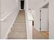 Carpeted staircase with white banister leading to the upper level at 10071 Yampa Ct, Commerce City, CO 80022
