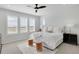 Bright bedroom featuring shutters, ceiling fan, and neutral colors provides an airy and relaxing atmosphere at 14998 Cast Pebble Cir, Parker, CO 80134