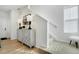 Bright entryway with stylish cabinet, modern lamps, and staircase access at 14998 Cast Pebble Cir, Parker, CO 80134