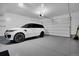 Spacious garage featuring a white SUV and ample room for storage and parking at 14998 Cast Pebble Cir, Parker, CO 80134