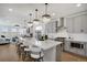 Bright, open kitchen with a large center island, pendant lighting, and stainless steel appliances overlooking the living area at 14998 Cast Pebble Cir, Parker, CO 80134