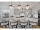 Bright kitchen with quartz countertops, stainless steel appliances, and large island with pendant lighting above provides a functional layout at 14998 Cast Pebble Cir, Parker, CO 80134