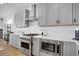 Modern kitchen with stainless steel appliances, including a range and microwave, and light gray cabinets for ample storage at 14998 Cast Pebble Cir, Parker, CO 80134