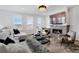 Elegant living room featuring a cozy fireplace, comfortable seating, and scenic views from the windows at 14998 Cast Pebble Cir, Parker, CO 80134