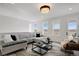 Spacious living room with a sectional sofa, modern decor, and large windows with neighborhood views at 14998 Cast Pebble Cir, Parker, CO 80134