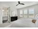 Stylish bedroom with shuttered windows, ceiling fan, and an en suite bath that offers a spa-like experience at 14998 Cast Pebble Cir, Parker, CO 80134