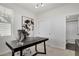 Bright home office with black desk, contemporary art, and access to the bathroom at 14998 Cast Pebble Cir, Parker, CO 80134