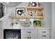 The stylish wet bar with wine storage, beverage fridge, quartz countertop, and open shelving will elevate any social gathering at 14998 Cast Pebble Cir, Parker, CO 80134
