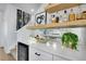 The elegant wet bar includes a wine refrigerator, display shelves, and a mirrored backsplash adding to its appeal at 14998 Cast Pebble Cir, Parker, CO 80134