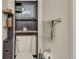Compact bathroom featuring toilet, decorative shelving, and chrome accessories for a clean look at 13901 E Marina Dr # 113, Aurora, CO 80014