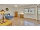 Cozy bedroom with a large window, ceiling fan, and light parquet flooring at 13901 E Marina Dr # 113, Aurora, CO 80014