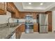 Bright kitchen featuring stainless steel appliances, granite countertops, and ample wood cabinet storage at 13901 E Marina Dr # 113, Aurora, CO 80014