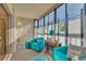 Bright sunroom with large windows, comfortable teal seating, and natural light at 13901 E Marina Dr # 113, Aurora, CO 80014