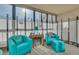 Cozy sunroom featuring large windows, comfortable seating, and a decorative fireplace at 13901 E Marina Dr # 113, Aurora, CO 80014