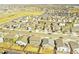 Birds eye view of suburban neighborhood with houses, backyards, and nearby park at 885 Hearthstone Ave, Brighton, CO 80601