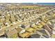 Overhead shot of a residential area with houses, cars, and streets at 885 Hearthstone Ave, Brighton, CO 80601