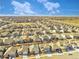 Expansive aerial view of a residential neighborhood showcasing similar homes and the beautiful landscape at 885 Hearthstone Ave, Brighton, CO 80601