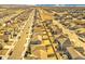 Wide aerial shot showcasing a neighborhood with orderly streets, homes, and community design at 885 Hearthstone Ave, Brighton, CO 80601