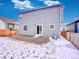 Exterior view of home showing door access to gravel patio and the yard, offering a private outdoor space at 885 Hearthstone Ave, Brighton, CO 80601