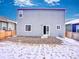 Exterior view of home showing door access to gravel patio and the yard, offering a private outdoor space at 885 Hearthstone Ave, Brighton, CO 80601