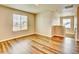 Bright bedroom with two windows and wood-look flooring at 885 Hearthstone Ave, Brighton, CO 80601